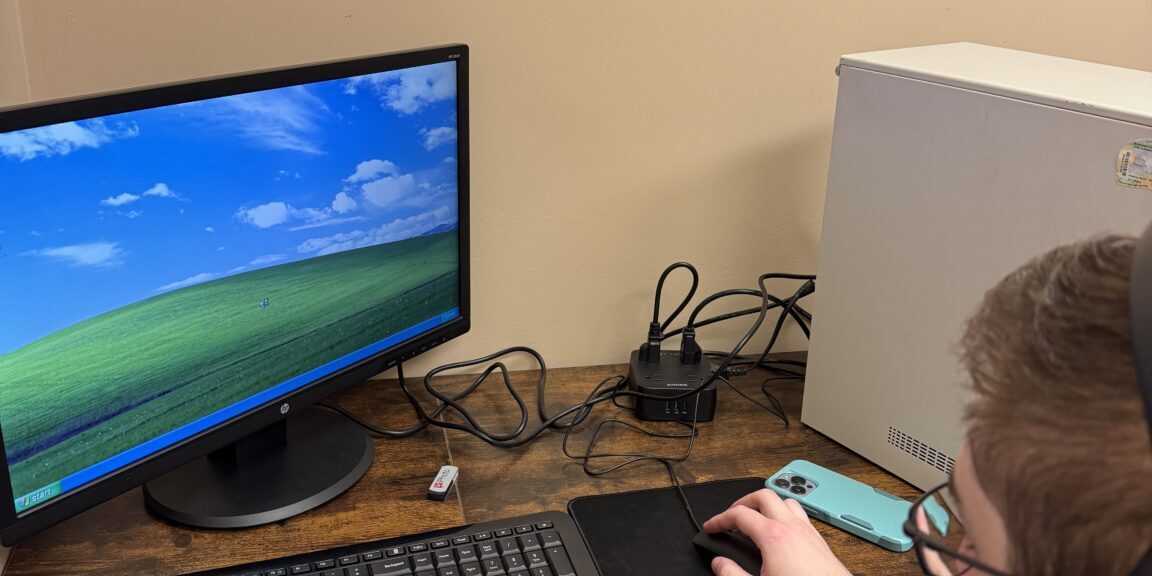 Nate working with an old Windows XP computer